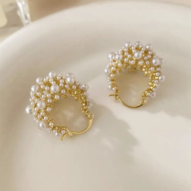 Gold-coloured copper flower basket earrings with rice-shaped bead inlay detail