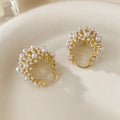 Gold-coloured copper flower basket earrings with rice-shaped bead inlay detail