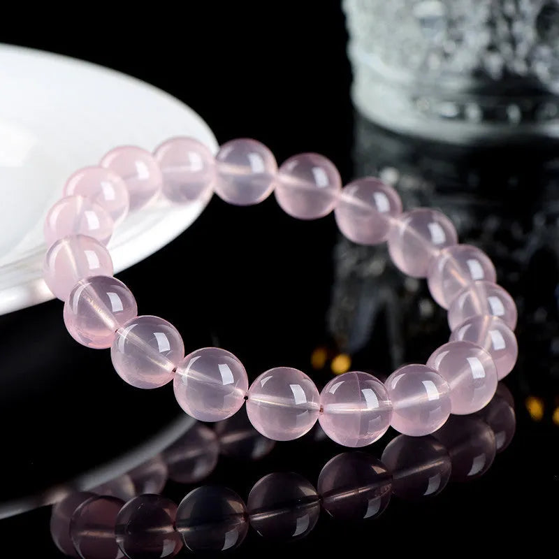 Natural starlight crystal round bead bracelet in pink, shown in a single circle design with polished beads.