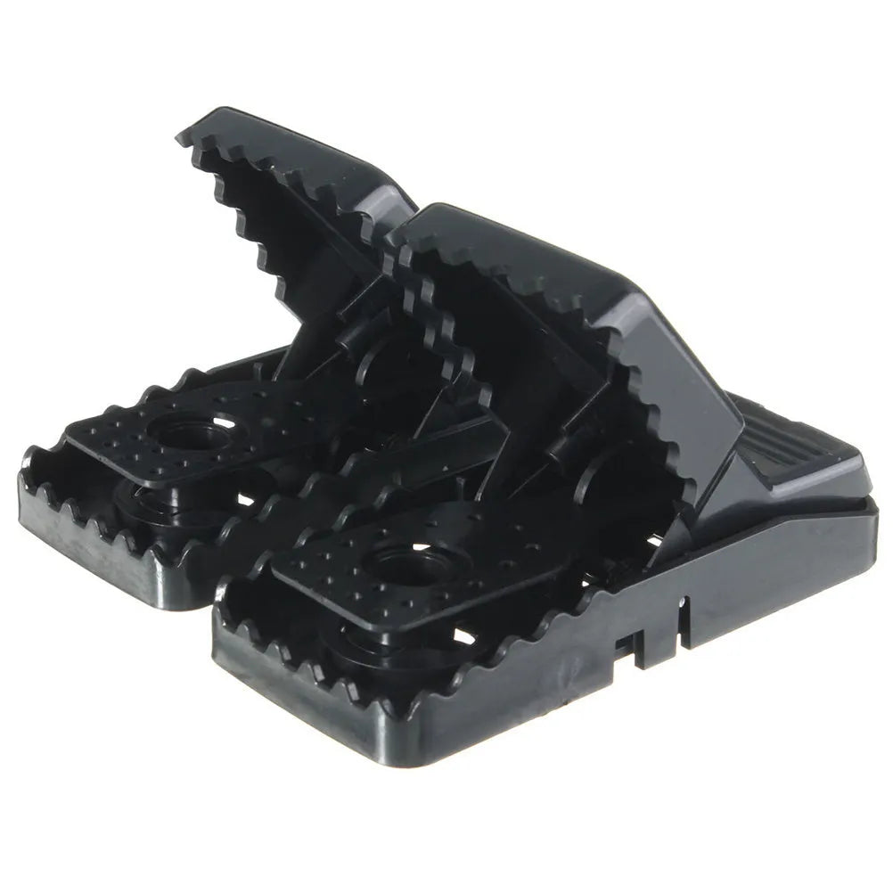 Six black plastic snapping mousetraps showing trigger mechanism and spring design