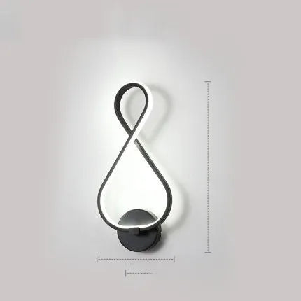 Nordic minimalist LED wall lamp with silicone shade in black finish mounted beside bed