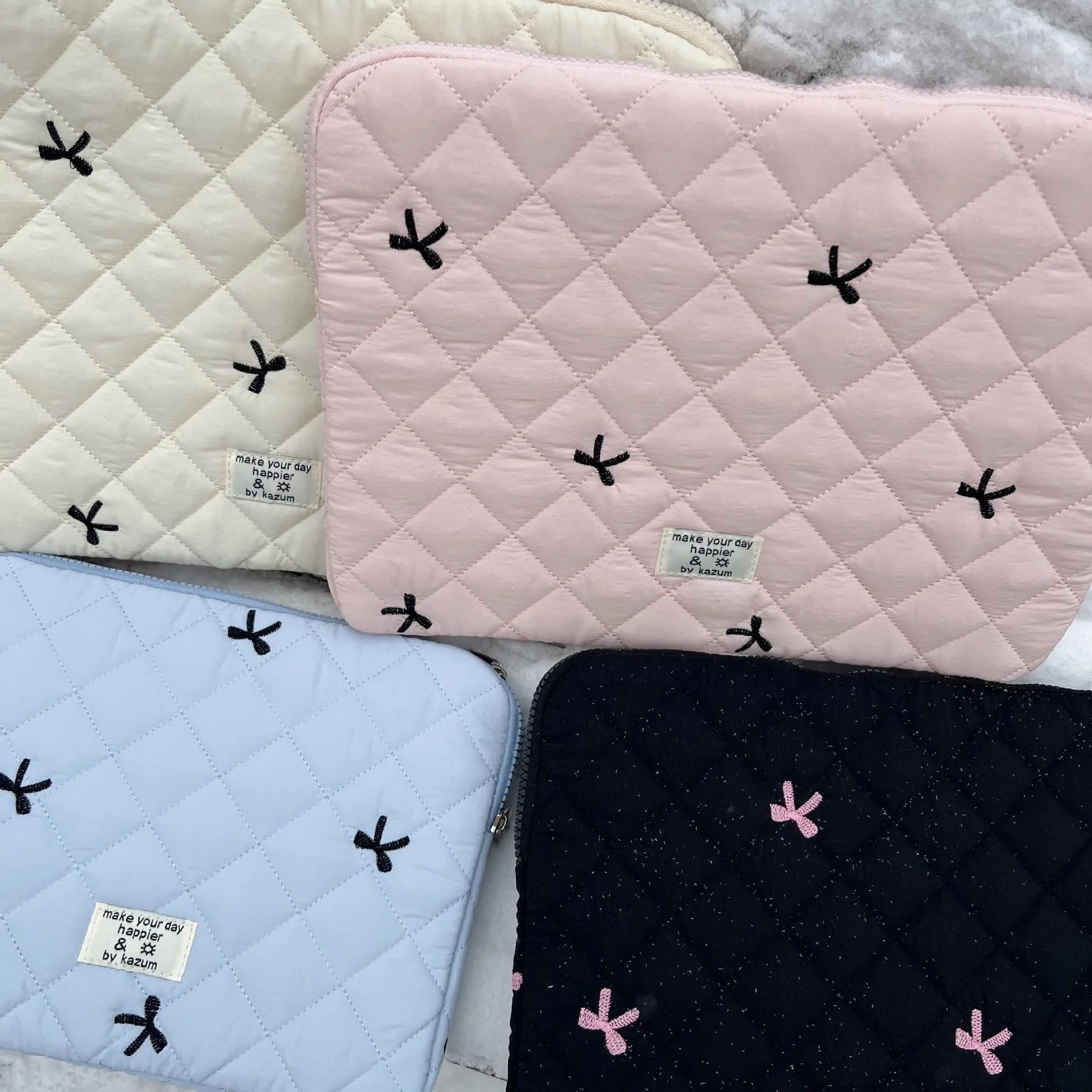 Cute rhombus embroidered bow laptop sleeve in light blue colour, zipper closure.