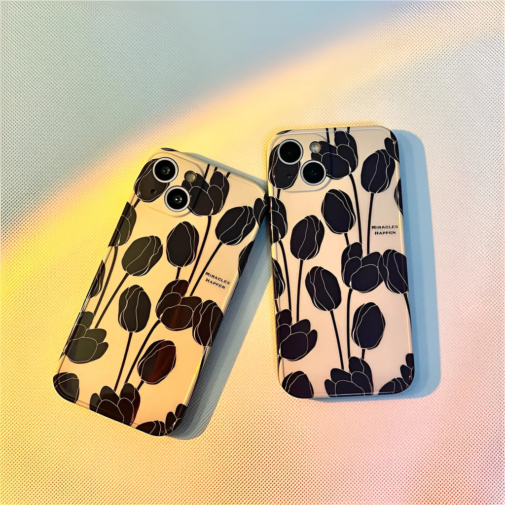 Black silicone iPhone case with a tulip pattern, shown on the back of a mobile phone.