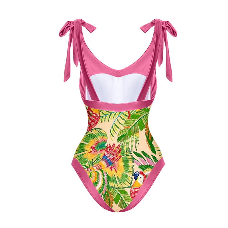 Pink floral retro one-piece swimsuit for women with V-neck and attached skirt on a hanger.