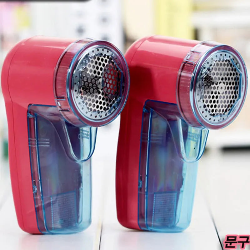 Portable electric lint remover handheld device on a blue background.