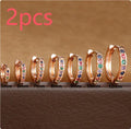 Gold, rose gold, and silver circle stud earrings with a perforated geometric design in various sizes.