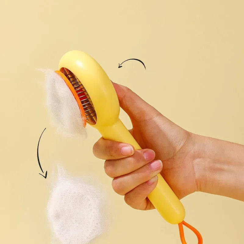 Small yellow duck-shaped pet comb with needle bristles for hair removal on cats and dogs.