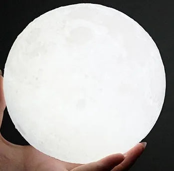 3D printed moon lamp with lunar surface detail on wooden stand, showing touch metal ring at base
