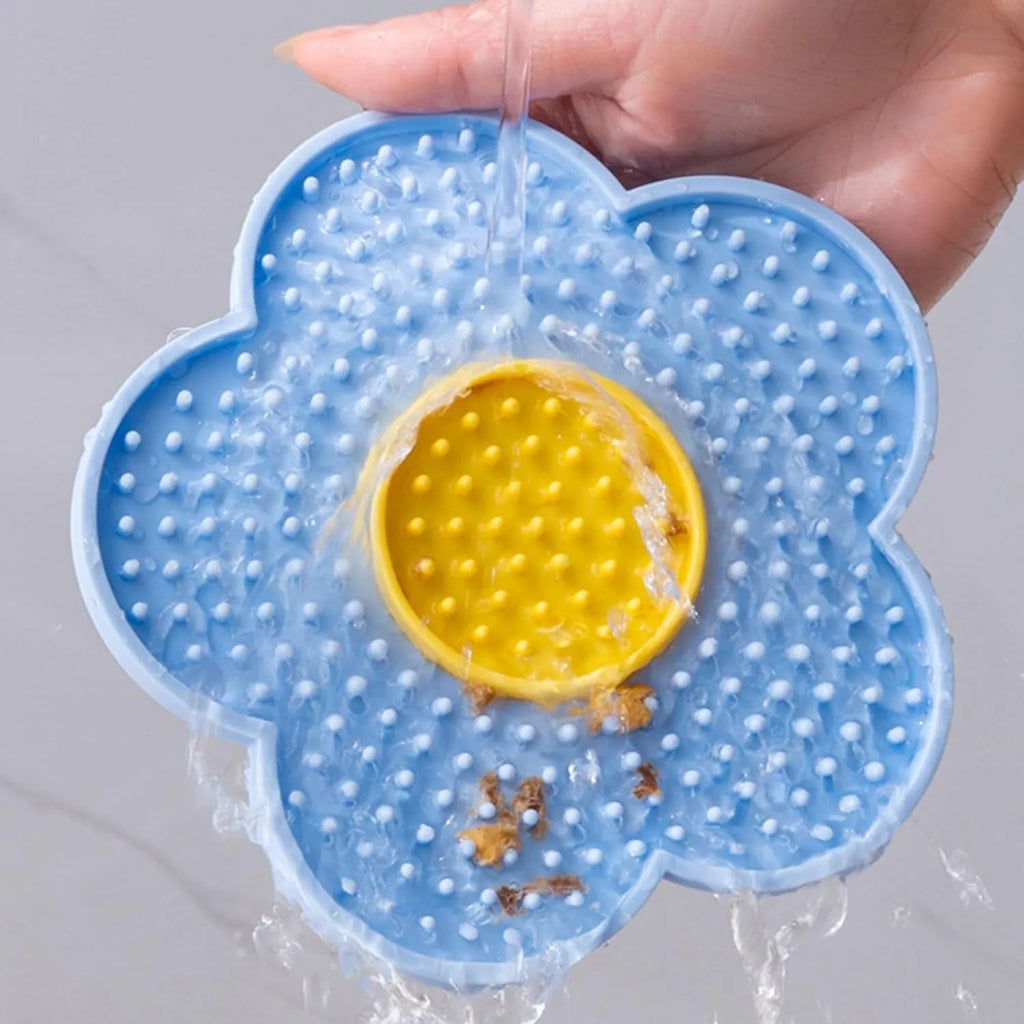 Flower-shaped silicone pet lick mat in assorted colours with suction cups on the base.