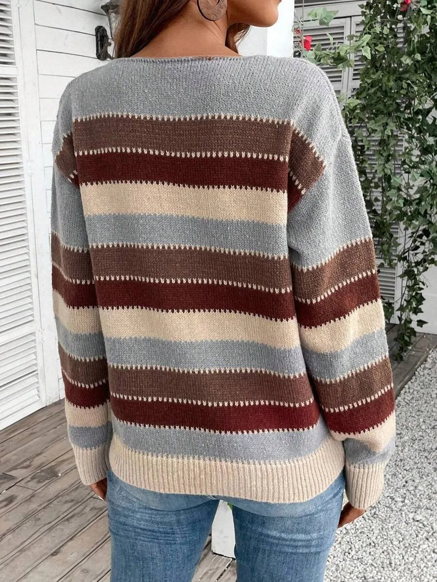 Women's black, blue, and grey colourblock striped polyester pullover sweater on a hanger.