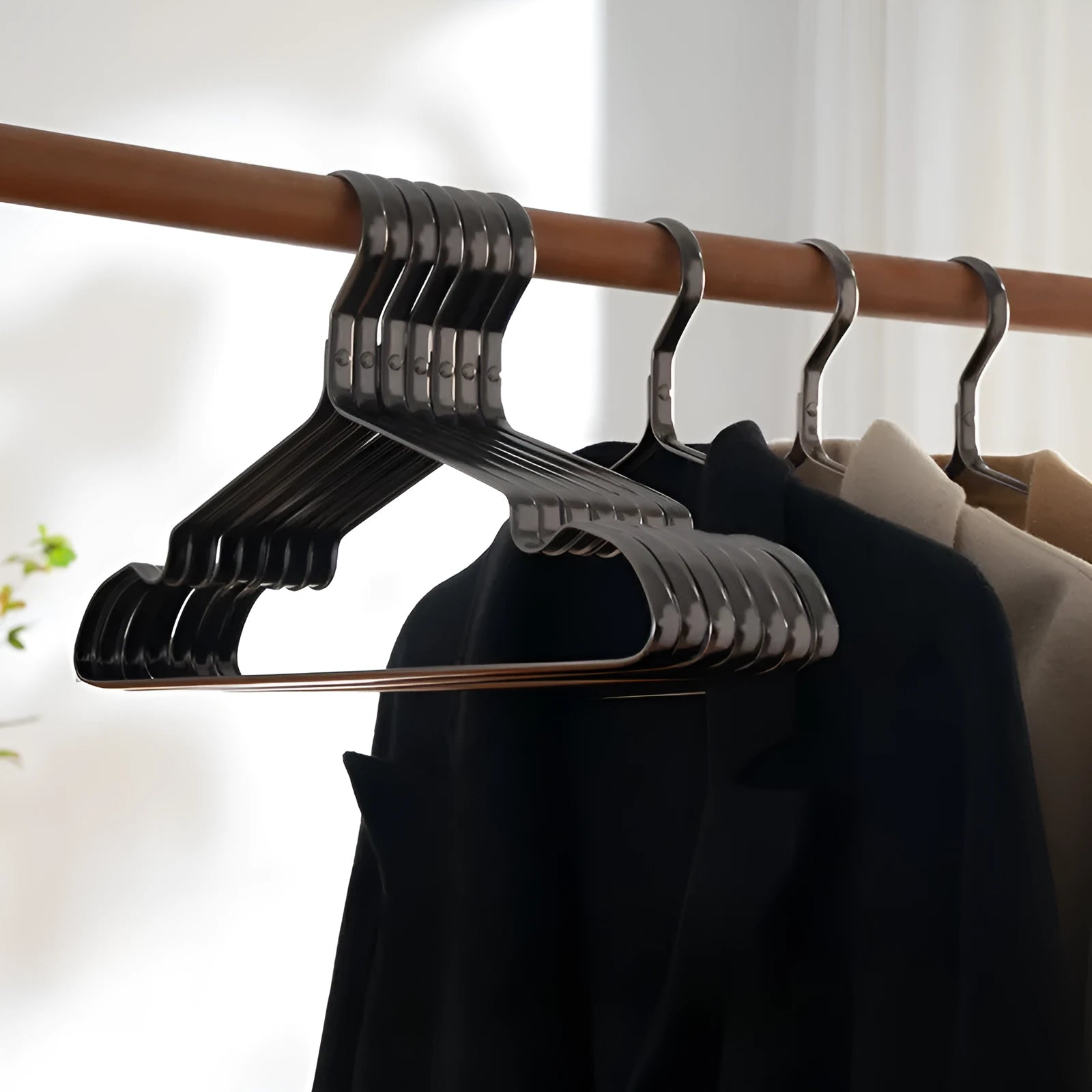 Elegant black modern minimalist clothes hanger with anti-slip coating.