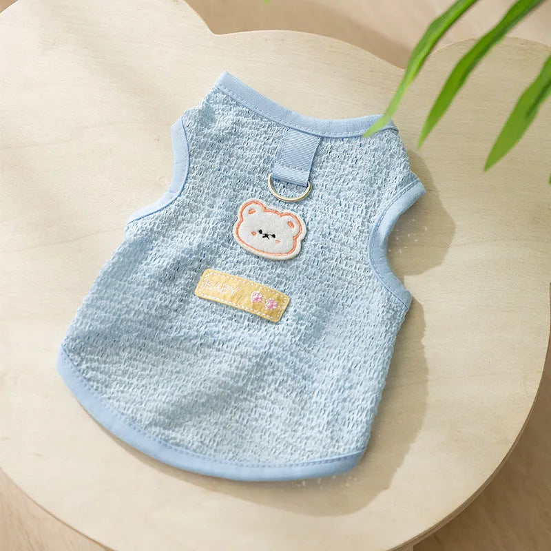 Cat wearing blue knitted clothing with bear patch and hollowed-out breathable design