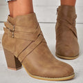 Grey PU leather short ankle boot with a 7cm chunky heel, side zip, and belt buckle on a wooden background.
