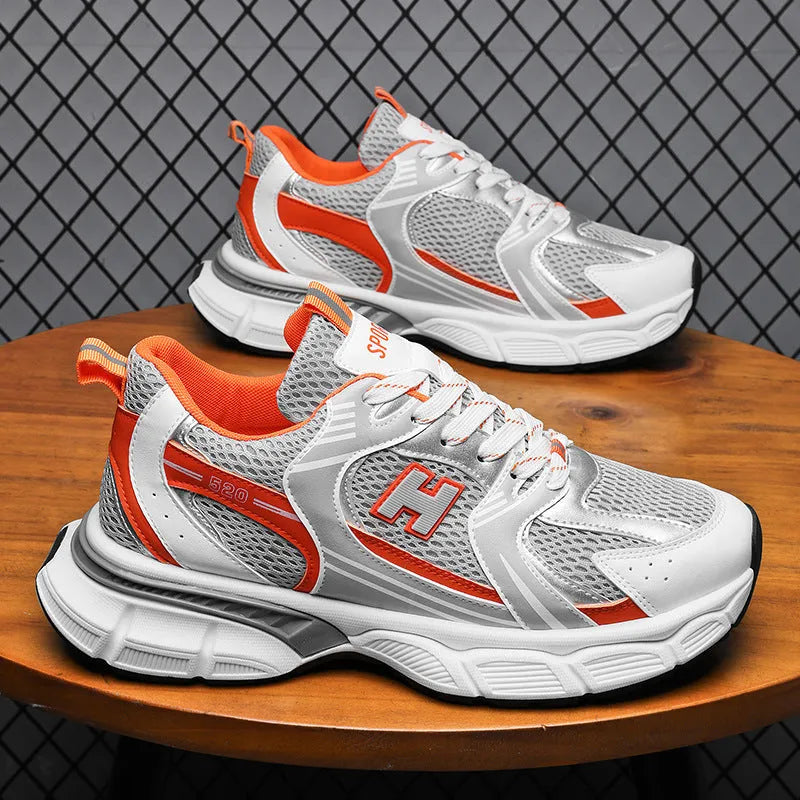 Men's solid colour mesh running shoes with a plastic sole, shown in black, white and grey, and white and orange.