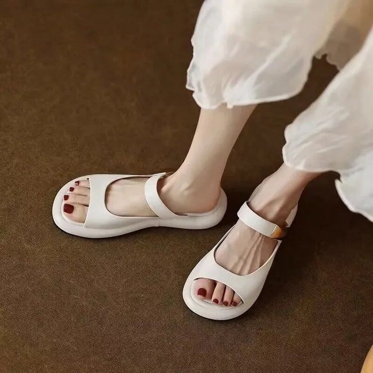 Women's apricot and white soft leather peep toe flat platform sandals with a rubber sole.