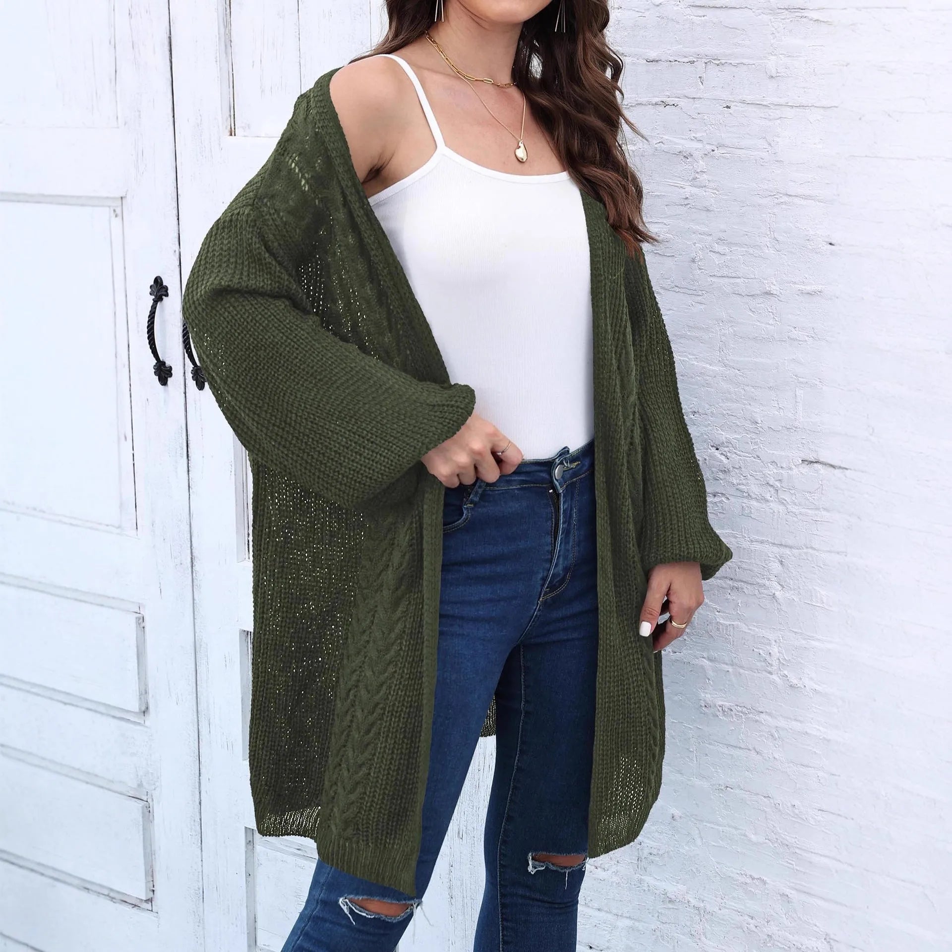 A woman's loose-fitting, solid-colour acrylic sweater coat on a hanger.