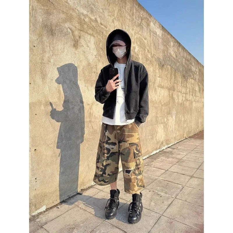 Men's camouflage cropped jeans with patchwork and ripped details in loose straight cut