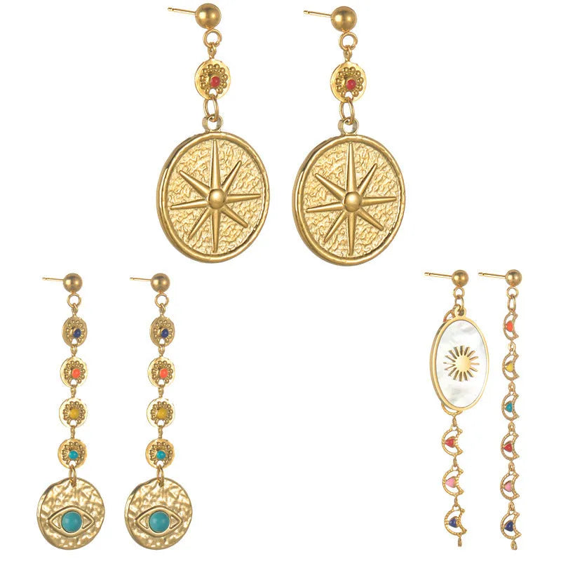 Geometric stainless steel stud earrings showing three colour options: Eight Awn XINGX, Eye, and Shell Sun designs.