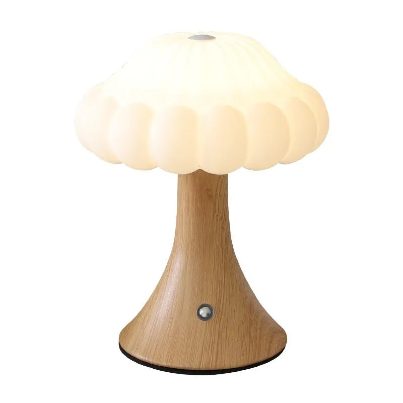 Wood grain coloured mushroom-shaped touch control night light on a wooden surface.