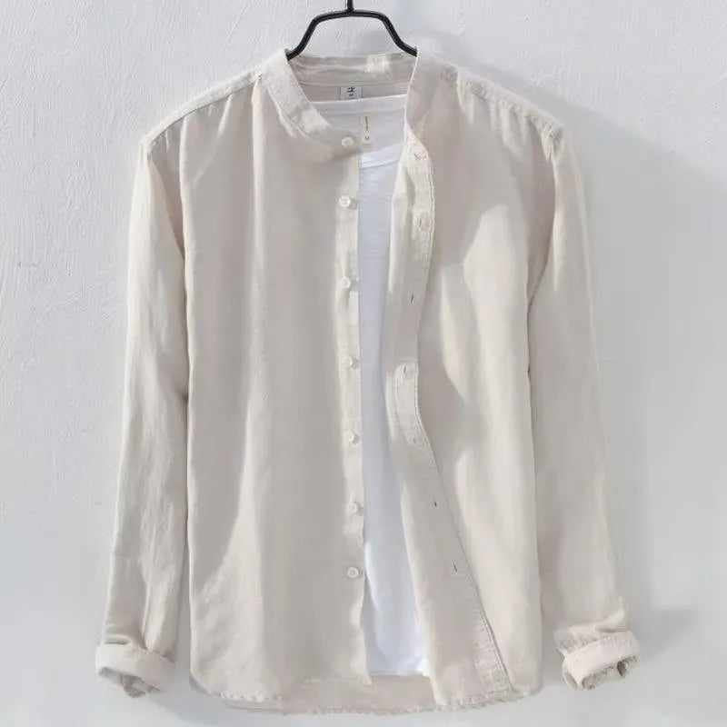 Man wearing a loose fit light blue linen blend long sleeve casual button-down shirt.