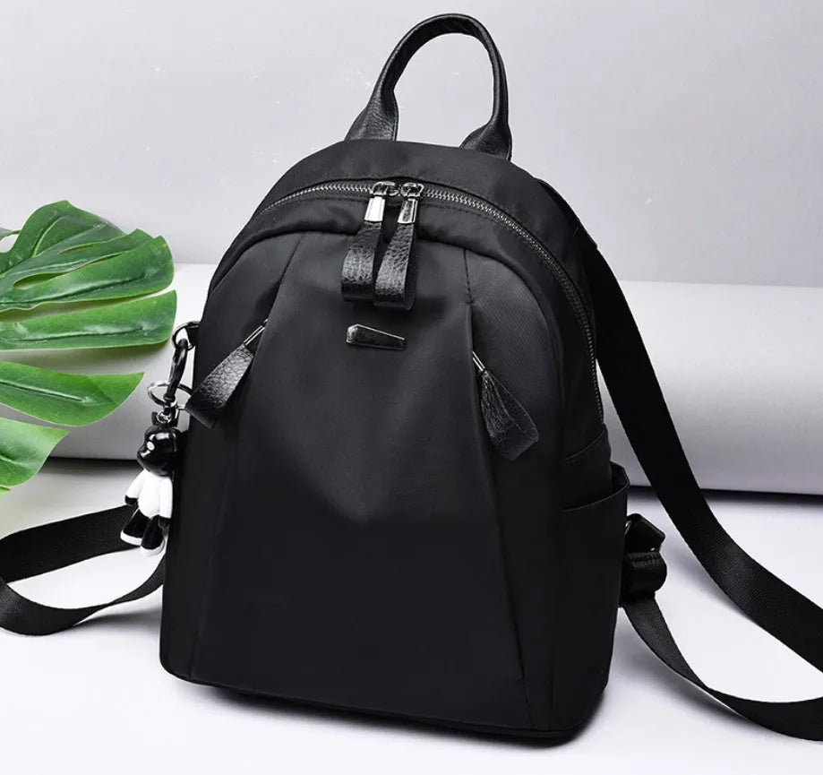 Medium wine red Oxford cloth rucksack with double shoulder straps showing internal organisers