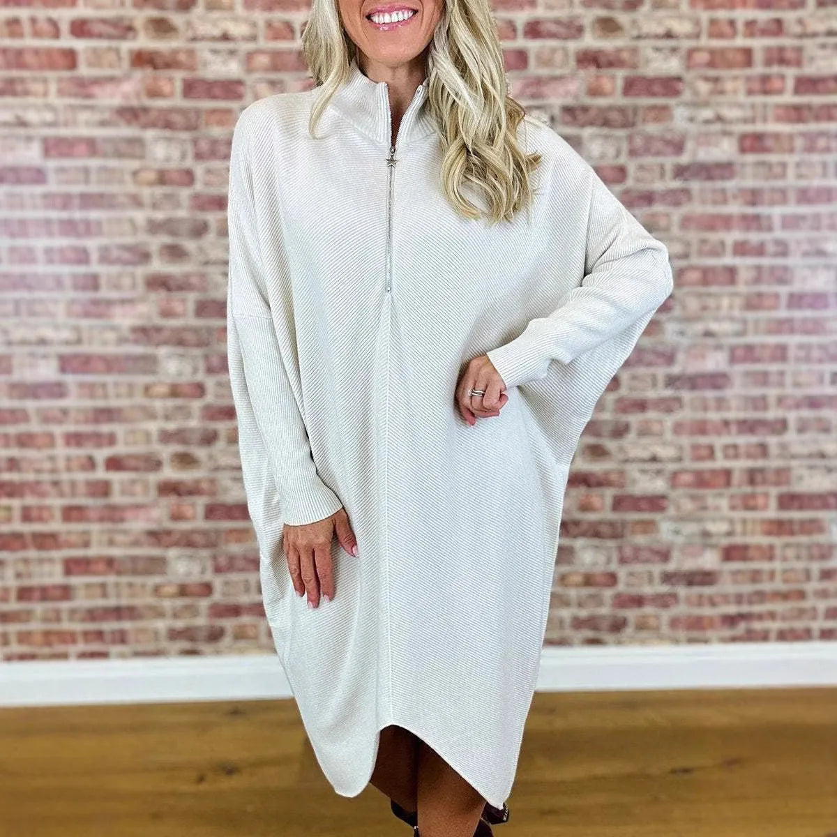 Women's solid colour knitted loose dress with zip and raglan sleeves, shown in dark green.