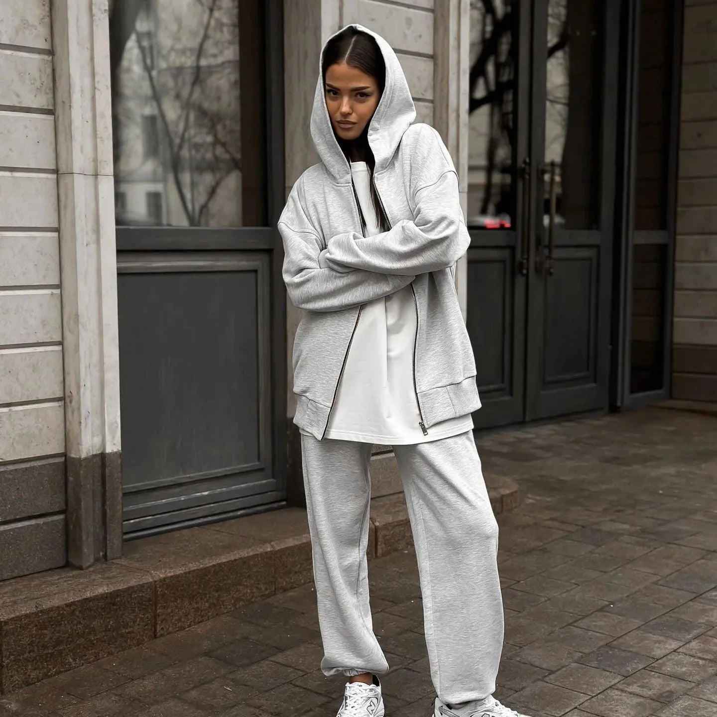 Women's loose fit polyester two-piece set with long-sleeved coat and trousers in a solid colour.