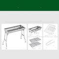 Large stainless steel folding barbecue grill set up for outdoor cooking.