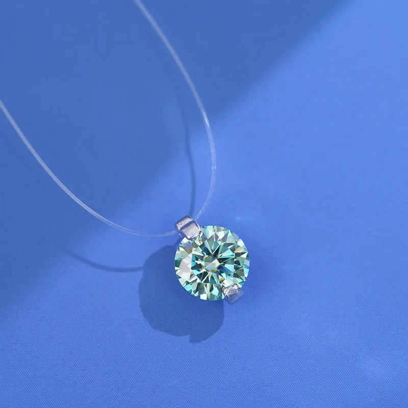 Women's sterling silver plum blossom necklace with a blue green moissanite stone on an invisible fishing line chain.