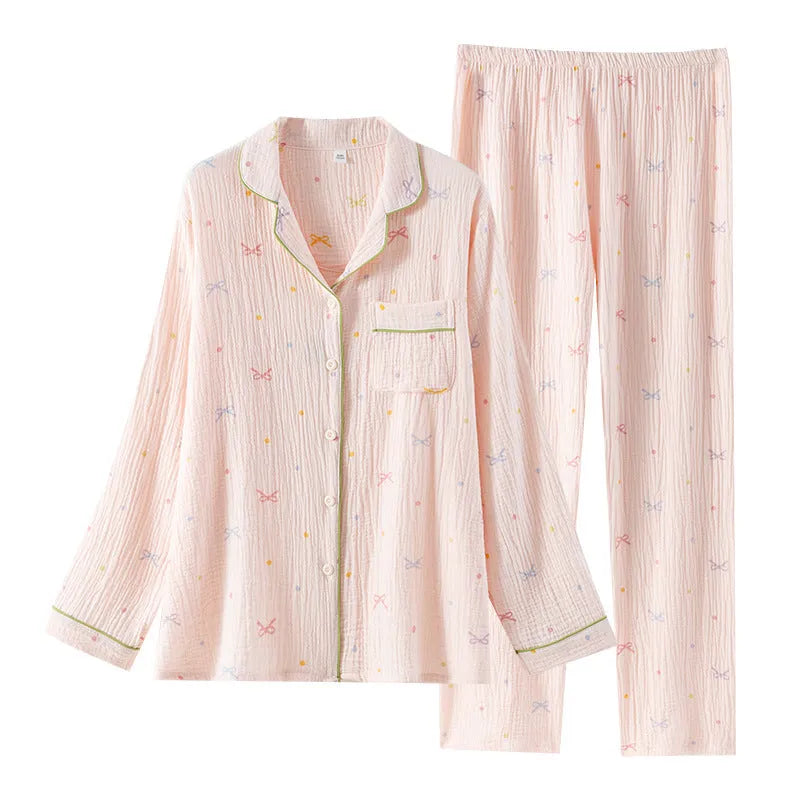 Women's long-sleeved cotton pyjama set in pink, showing top and trousers laid flat