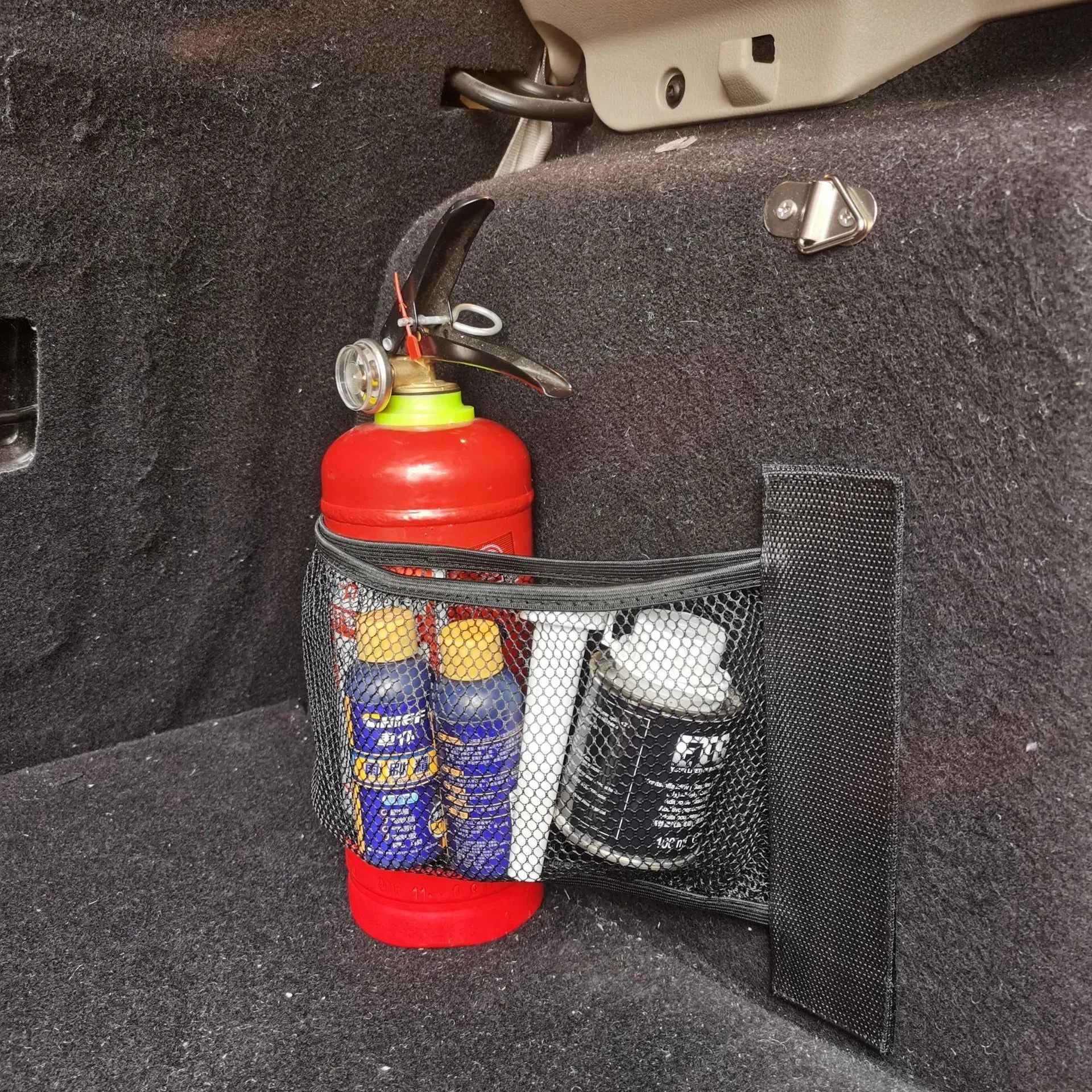 Elastic polyester car boot storage net shown with metal hooks and adhesive strips for organising loose items.