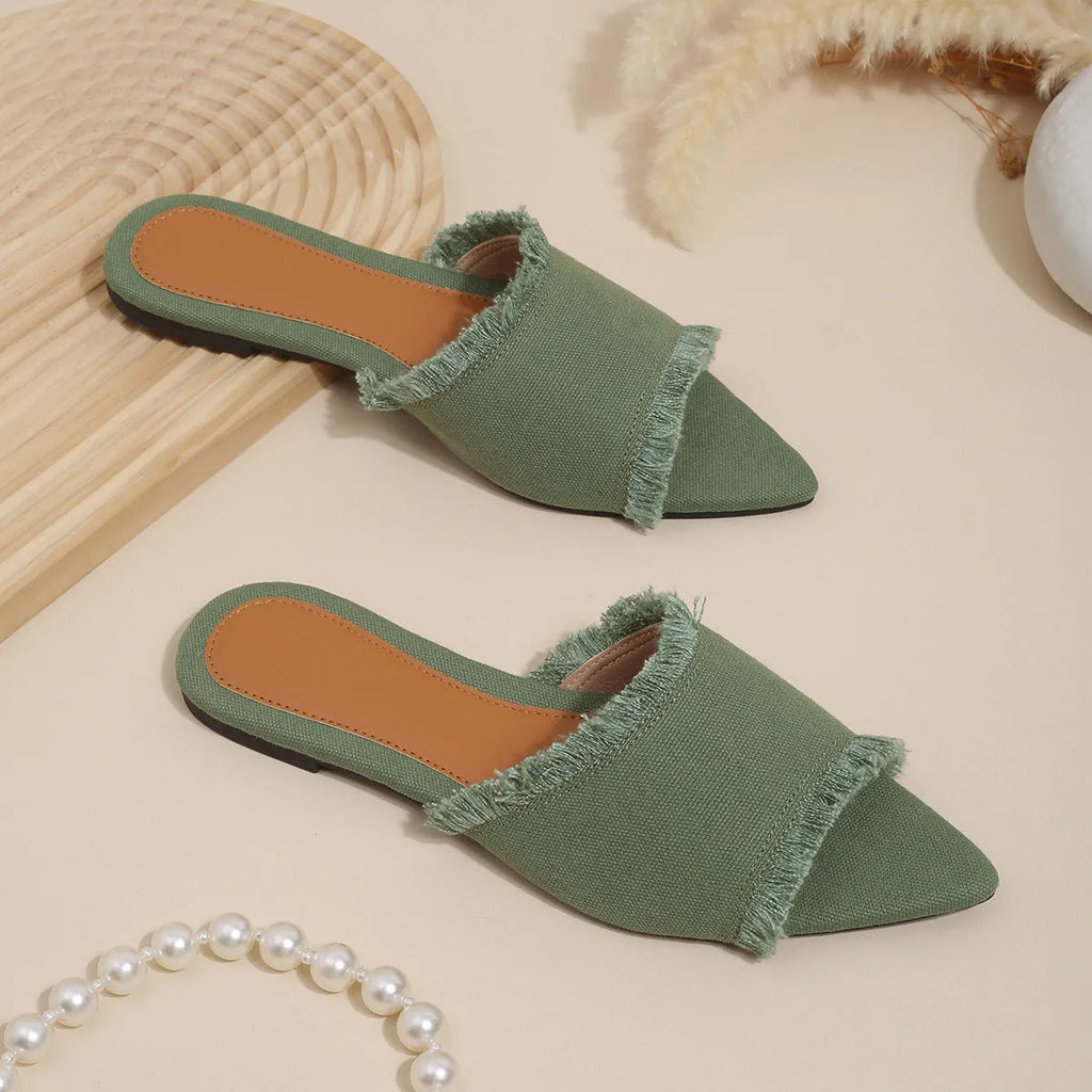 Women's flat denim slippers with a tassel detail, shown in apricot colour.