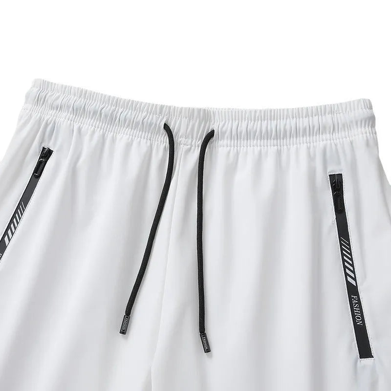 Man wearing black loose-fit quick-drying nylon sports shorts for summer activity.