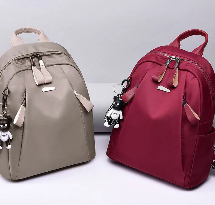 Medium wine red Oxford cloth rucksack with double shoulder straps showing internal organisers