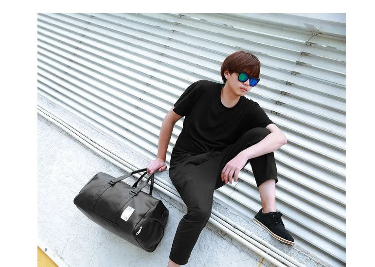 Black waterproof sports bag with diagonal straps and a separate shoe compartment, shown in large and small sizes.