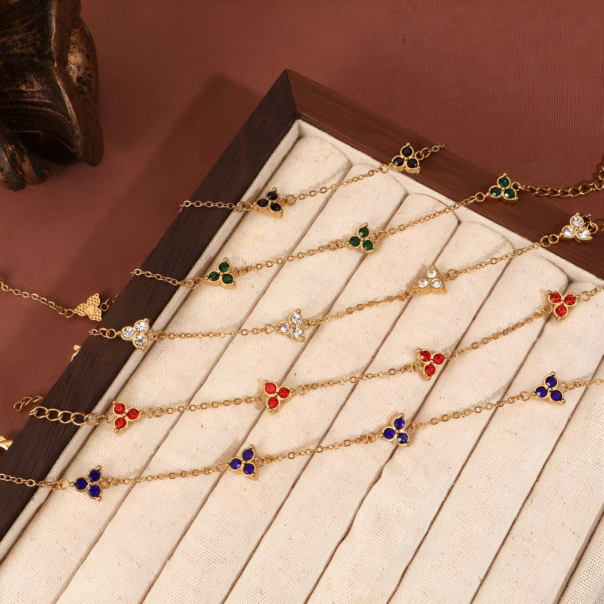 Women's stainless steel geometric bracelet with triangle design and coloured zircon stones.