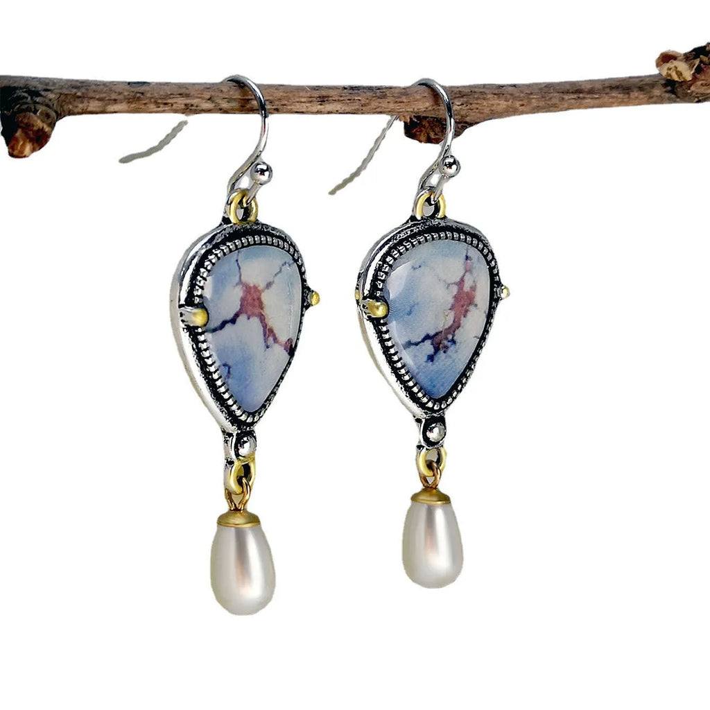 Retro blue geometric drop earrings with synthetic blue opal and white pearl on electroplated metal.