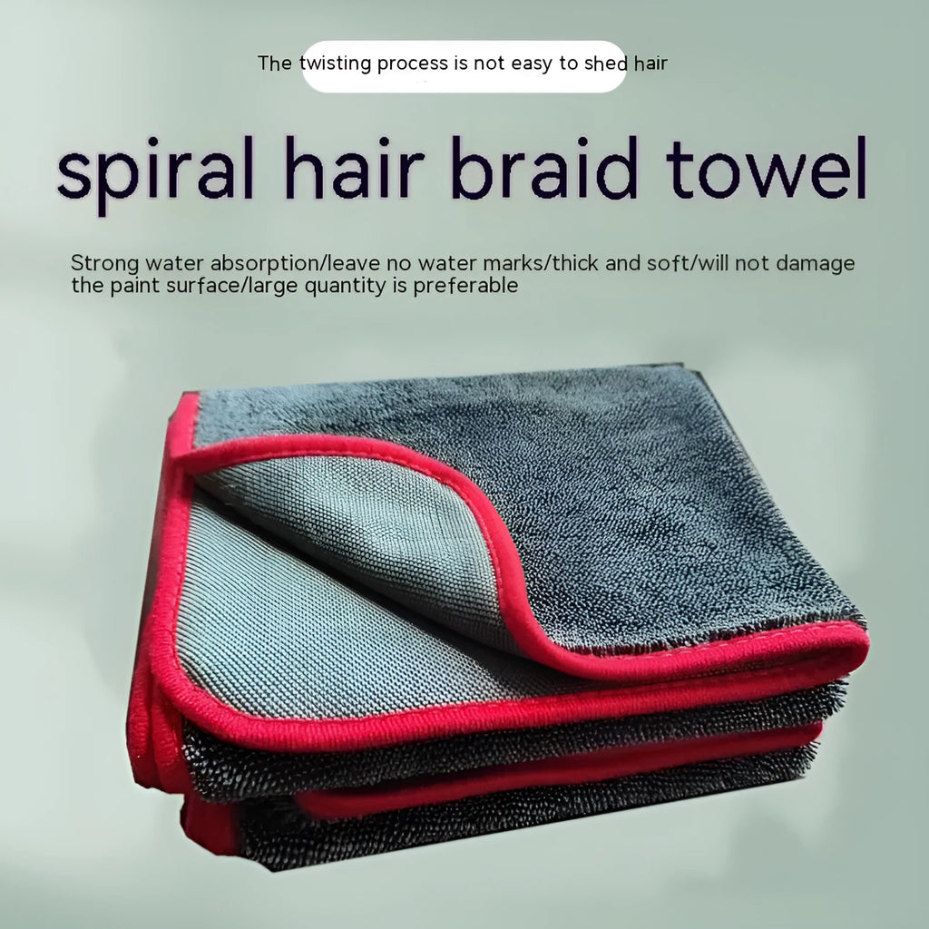 Grey automobile cleaning cloth with black edging showing spiral hair texture and hemmed edges
