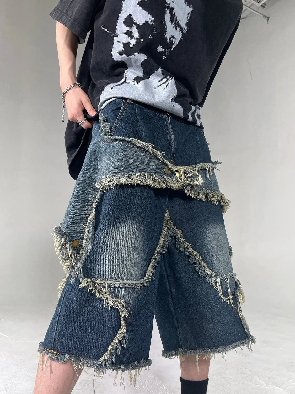 Men's blue denim shorts with frayed edges and five-pointed star design, loose fit for summer