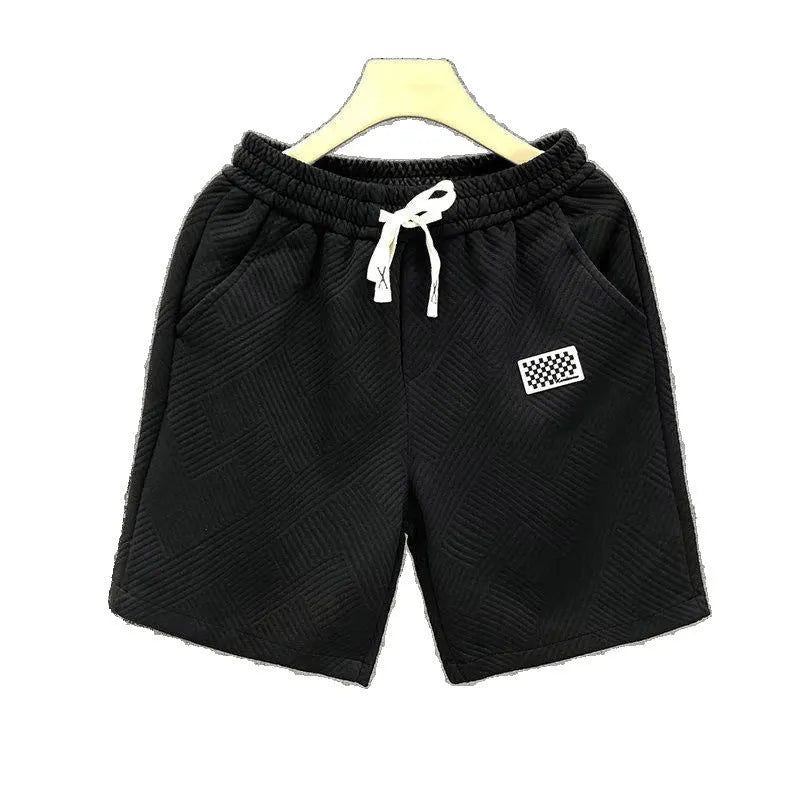Solid colour polyester sports shorts with elastic waist on a mannequin, shown in black.