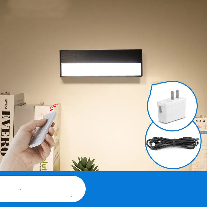 White rechargeable magnetic LED desk lamp with large light surface on a wooden desk.