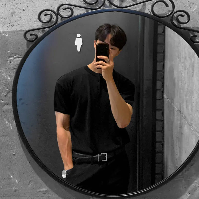 Man wearing a thin black short-sleeved ice silk knitted pullover shirt with a slim loose fit.
