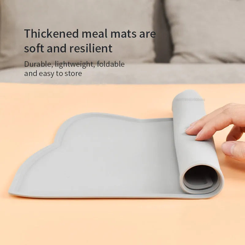 Blue silicone pet feeding mat under food and water bowls measuring 44 by 24 centimetres