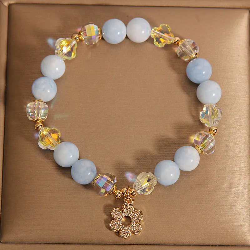 Women's aquamarine crystal bracelet with a four-leaf clover charm and pearl decorative accents