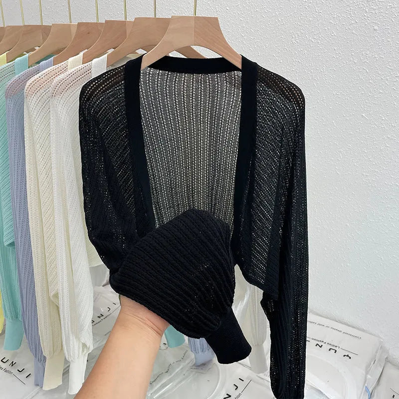 Thin polyester blouse with long hollow lantern sleeves in apricot colour, slim fit.