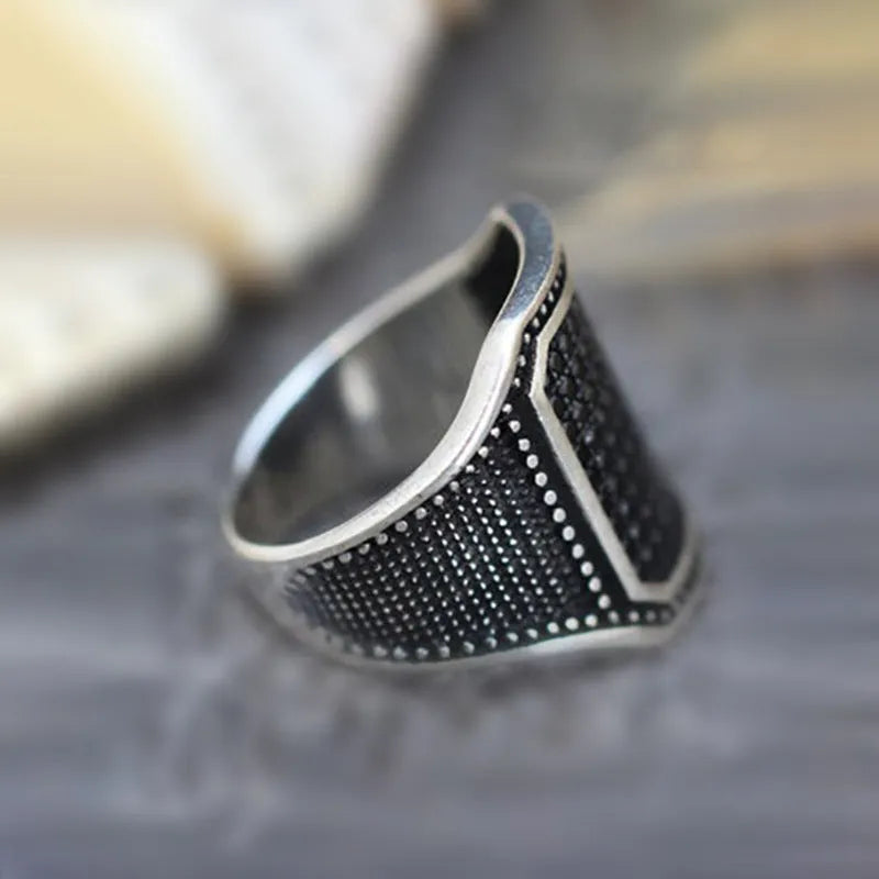Black alloy ring with copper inlay and zircon stone detail shown in unisex design