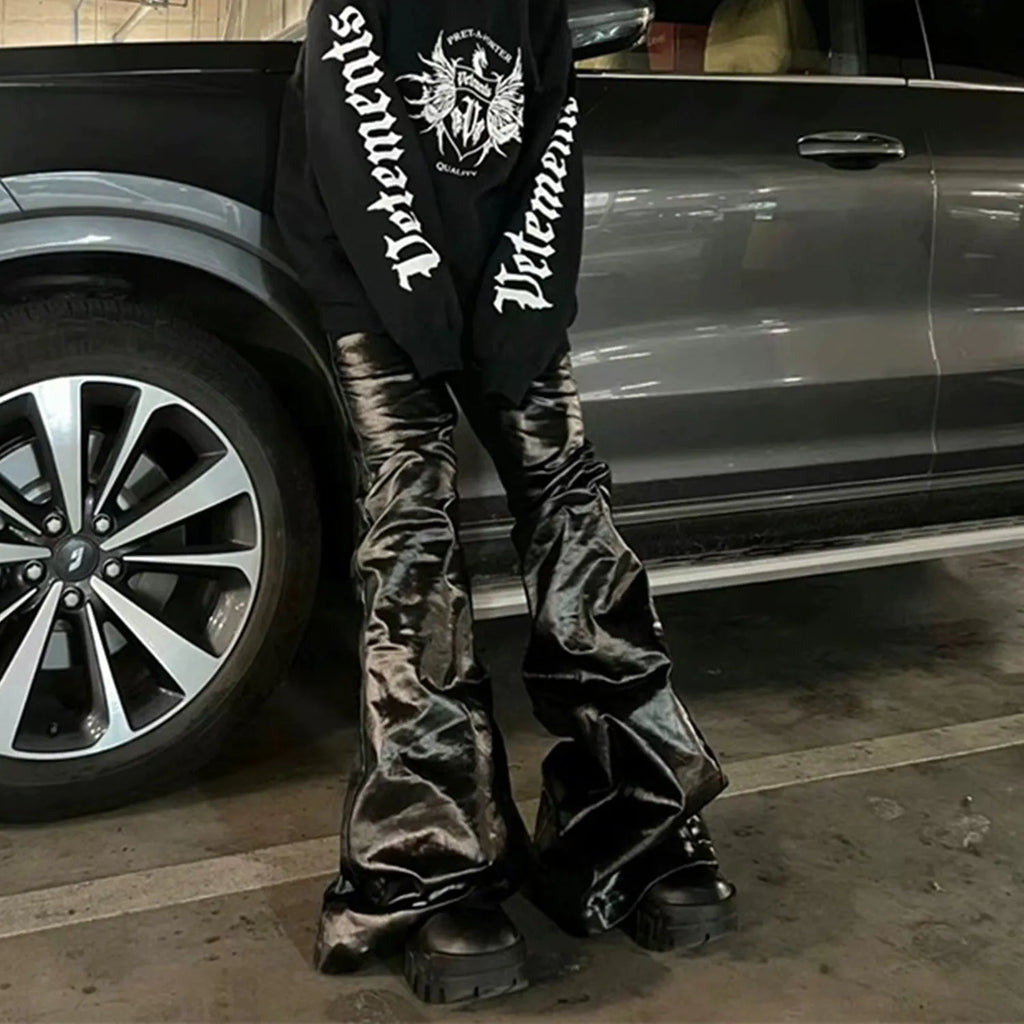 Black straight-leg skinny jeans with a shiny patent leather finish and a mid waist.