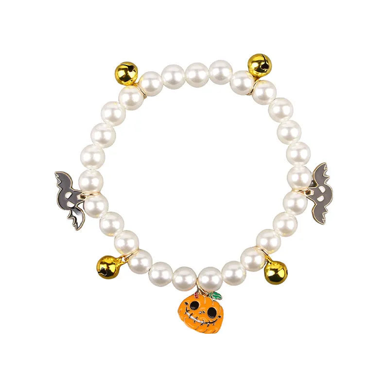 Halloween decorative pet collar with simulated pearls and a pumpkin charm.