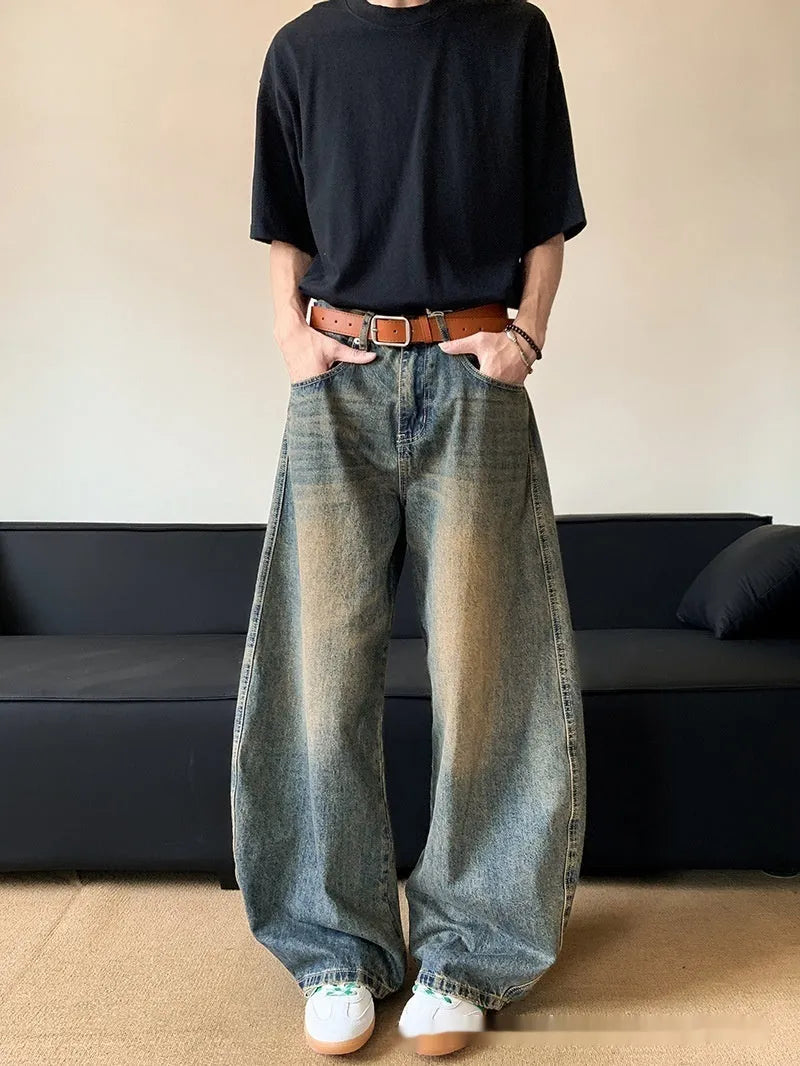 Men's distressed retro blue denim trousers with wide-leg silhouette and micro-elastic cotton-blend fabric