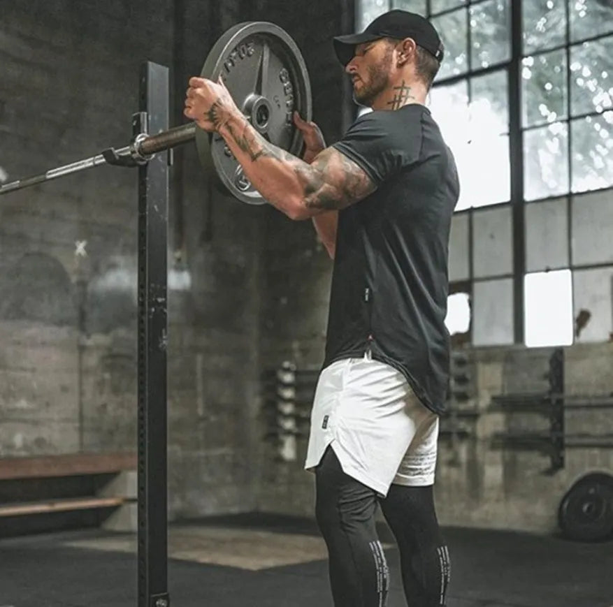 A plain men's grey gym shirt made from cotton and spandex fabric on a hanger.